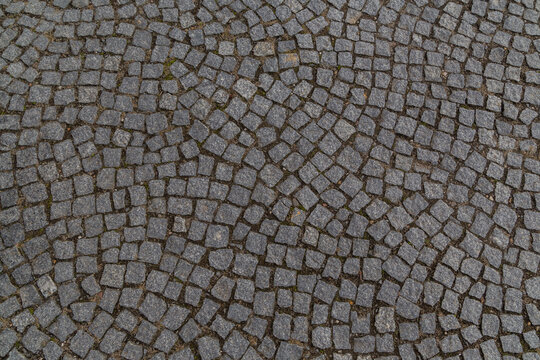 old granite cobblestones close up lined with an arc