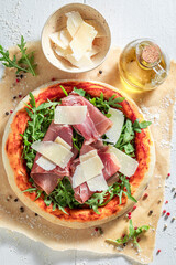 Tasty pizza Parma with parmesan cheese and parma ham