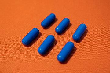 Blue pills on the orange background