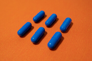Blue pills on the orange background