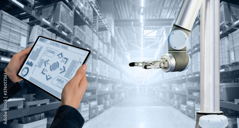 Aufkleber Warehouse manager with digital tablet controls robot arm
