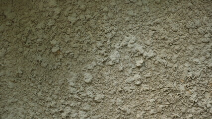 plastered rough wall with burnt out irregularities of the textured surface