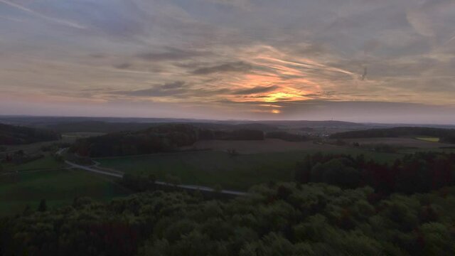 Drone is flying above bavarian fields during sunset