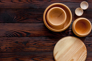 Making wooden dishes. Empty bowls on brown wooden background top view copy space