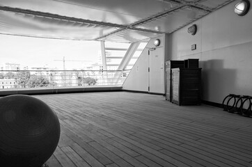 Staying fit with muscle fitness stretching like yoga or pilates on outdoor terrace or patio of...