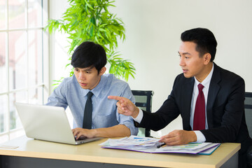 The supervisor is teaching the new employee.