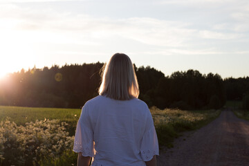 young woman walking on the road