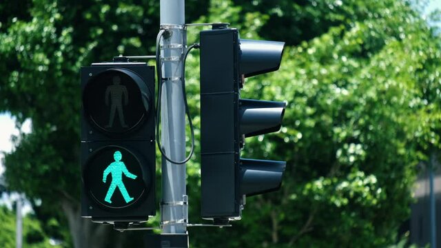Traffic light turns from red to green at financial district intersection.