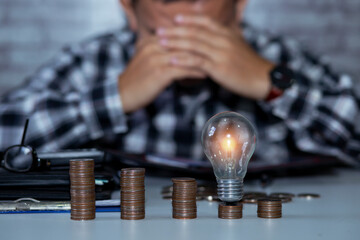 Business man holding light bulb on the Green background nature and writing on note book it for financial