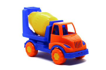 Naklejka premium Children's plastic multi-colored toy concrete mixer on a white background. Toy vehicles, outdoor games for children.