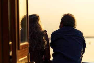 Couple in love during romantic summer evening cruise