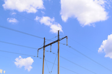 Bottom view of a high-voltage pole against the sky. Electricity