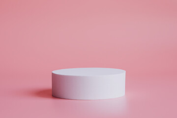 White podium on a pink background, for the presentation of products and cosmetics.