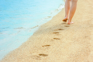 Fototapeta na wymiar beautiful footprints in the sand by the sea background