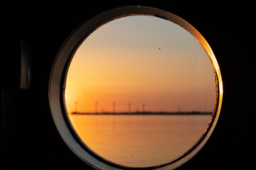 Boat porthole with lake view close up