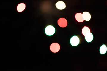 Multicolored bokeh spots on a black background.