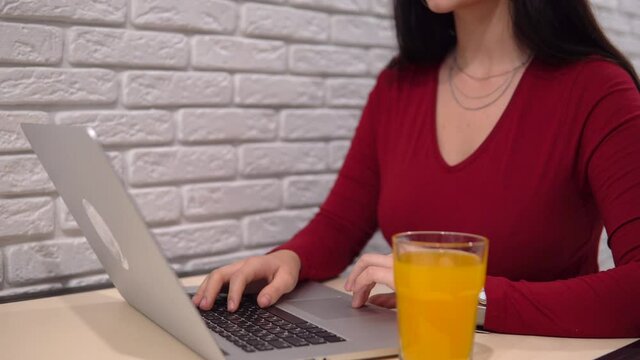 Woman using laptop, office worker, freelance online remote work, orange fresh