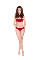 Obraz premium Full length portrait of an attractive cheerful woman wearing red bra and panties, studio photo isolated in front of white background