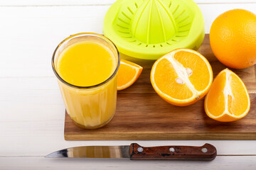 Fresh orange juice on a white table.