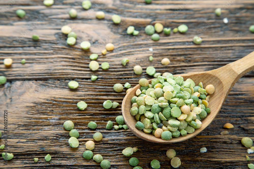 Wall mural peas in a spoon on the table