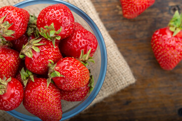 Ripe red strawberries on wooden table