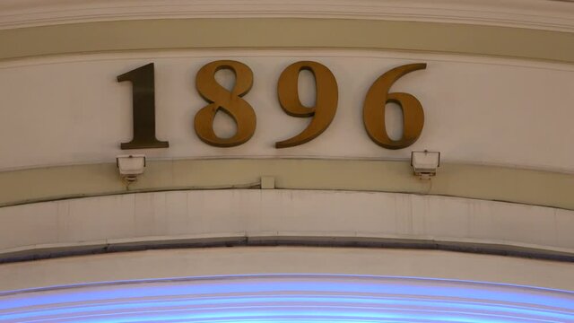 Numbers 1896 on facade of building with RGB LED backlighting. Numbers 1896 on facade of building with RGB LED backlighting. Building of Moscow House of Artists. Art salon. Passage San Galli - an exhib