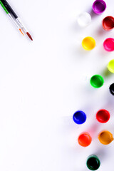 A flat lay for an artist with paint and brush