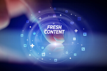 Finger touching tablet with social media icons and FRESH CONTENT