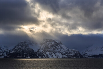 Fototapeta na wymiar Dramatic clouds over snow-capped mountains of the Lyngen Alps, Lyngen Peninsula, Troms, Norway