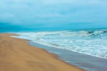 Beautiful sea shore with blue sky and mild waves
