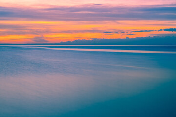 Fototapeta na wymiar Minimalist sunset over water with copy space