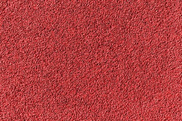 Surface of Red rubber pellets in treadmill athletics field texture abstract background