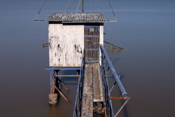 Typical old wooden fishing huts on stilts in the atlantic ocean in saint-Nazaire in France