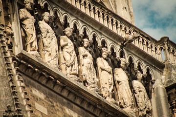 View of the exterior facade of the Roman Catholic Notre Dame de Reims Cathedral, a historical...