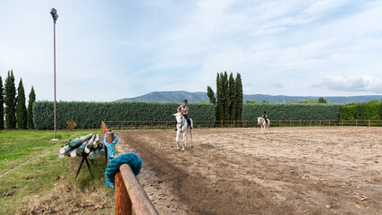 Fototapeta na wymiar Instructor teaches kid Equestrian. Horseriding school