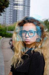 Augmented reality glasses. Smart glasses. Girl in augmented reality glasses. Nanotechnology. Young girl with glasses. A look into the future. Augmented reality.