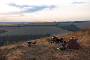 Camping at the top of the mountain. Wilderness. Motorcycle and tourist tent, camp. Active lifestyle and vacation concept. Bike Adventure. Romantic look. Freedom. Dniester River Ukraine