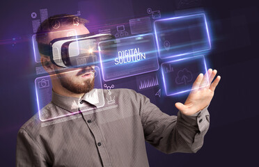 Businessman looking through Virtual Reality glasses with DIGITAL SOLUTION inscription, new technology concept