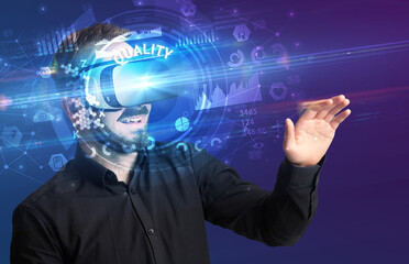 Businessman looking through Virtual Reality glasses with QUALITY inscription, innovative technology concept