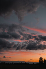 Colorful and dramatic sunset view with illuminated clouds and burning sky and nature countryside view