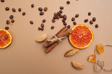 Obraz na płótnie Canvas Citrus and spicy background with coffee beans and spices, warm ochre background
