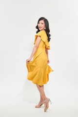 Portrait of a beautiful young woman in yellow dress and turn around.