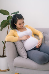 smiling pregnant asian woman