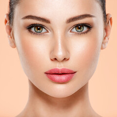 Fototapeta premium Portrait of beautiful young brunette woman with clean face. Closeup face of young adult woman with clean fresh skin.