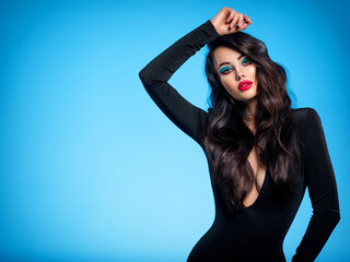 Portrait of beautiful young woman with bright blue makeup.  Pretty girl with long black hair....
