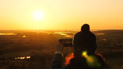 silhouette of a woman in sunshine, selfie, taking pictures at sunset, sunrise. Free Young girl...