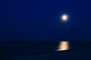 A Moon with reflection by the sea on nature background