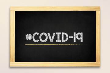 Obraz premium Coronavirus covid-19 hashtag made in chalk on blackboard
