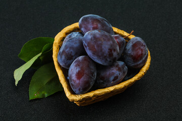 Ripe plum heap in the basket