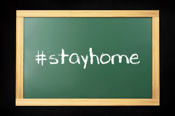 Obraz premium Stay home hashtag made in chalk on chalkboard